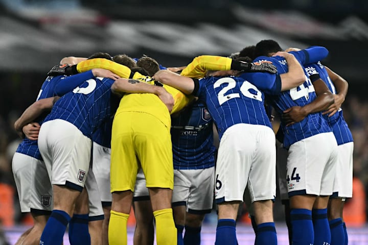 Ipswich's players huddle togethe